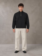 Model wearing SM Sig. Half-Zip Fleece Sweatshirt in Midnight Black, front view.
