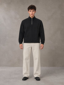 Model wearing SM Sig. Half-Zip Fleece Sweatshirt in Midnight Black, front view.