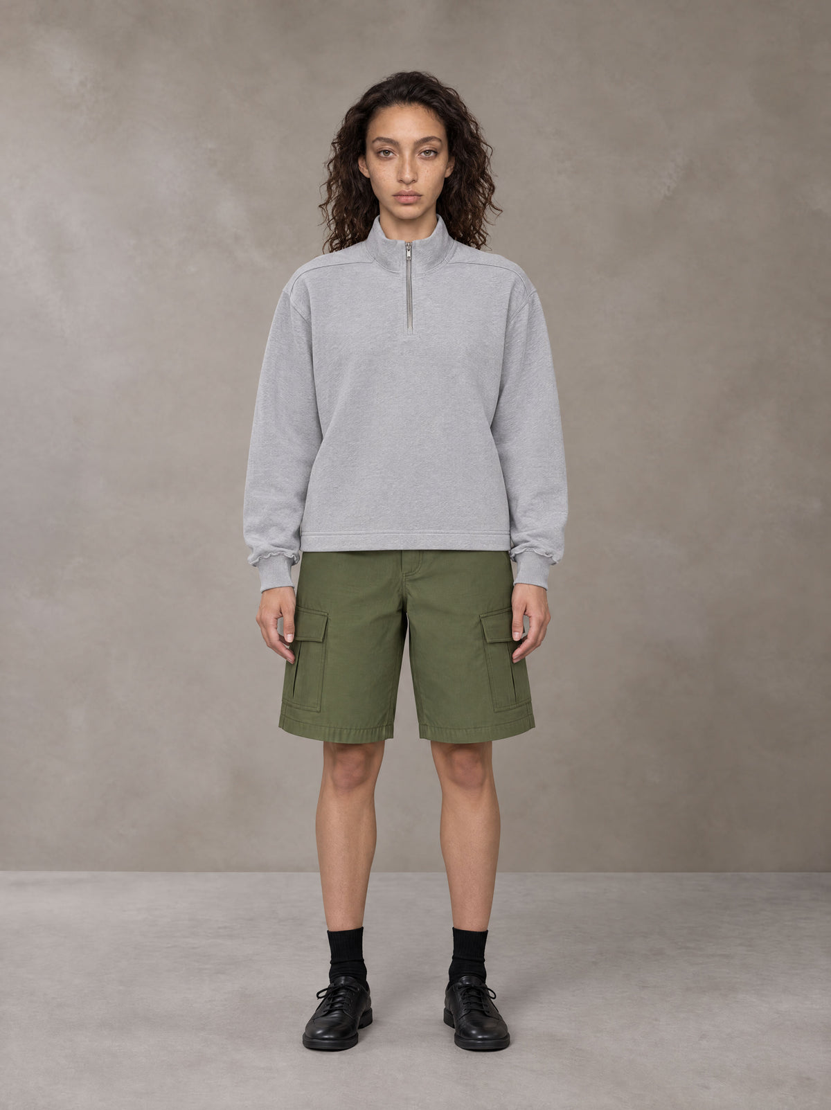 Model wearing SM Sig. Half-Zip Fleece Sweatshirt in Floral Grey, front view.