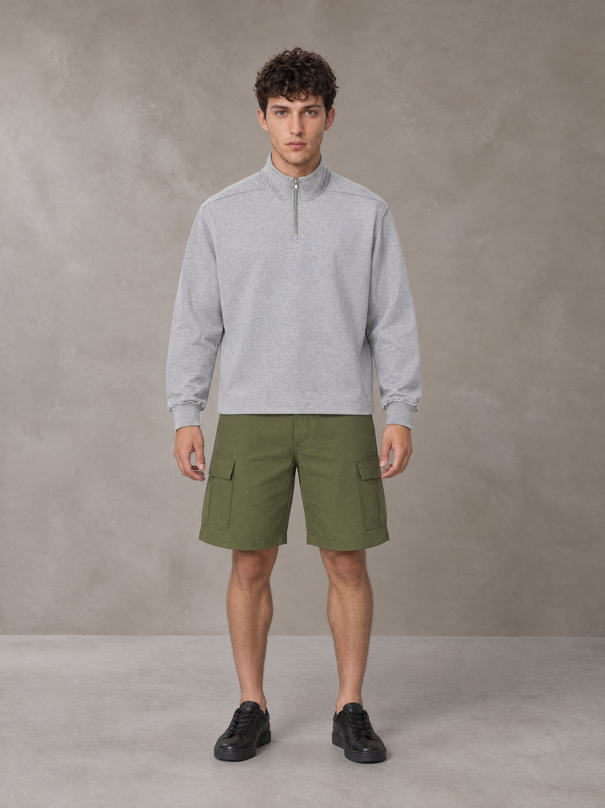 Model wearing SM Sig. Half-Zip Fleece Sweatshirt in Floral Grey, front view.