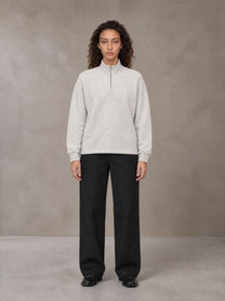 Model wearing SM Sig. Half-Zip Fleece Sweatshirt in Oat Grey, front view.