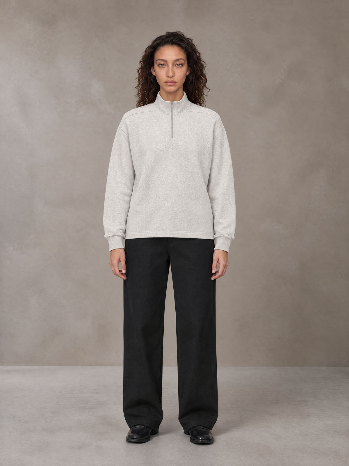 Model wearing SM Sig. Half-Zip Fleece Sweatshirt in Oat Grey, front view.