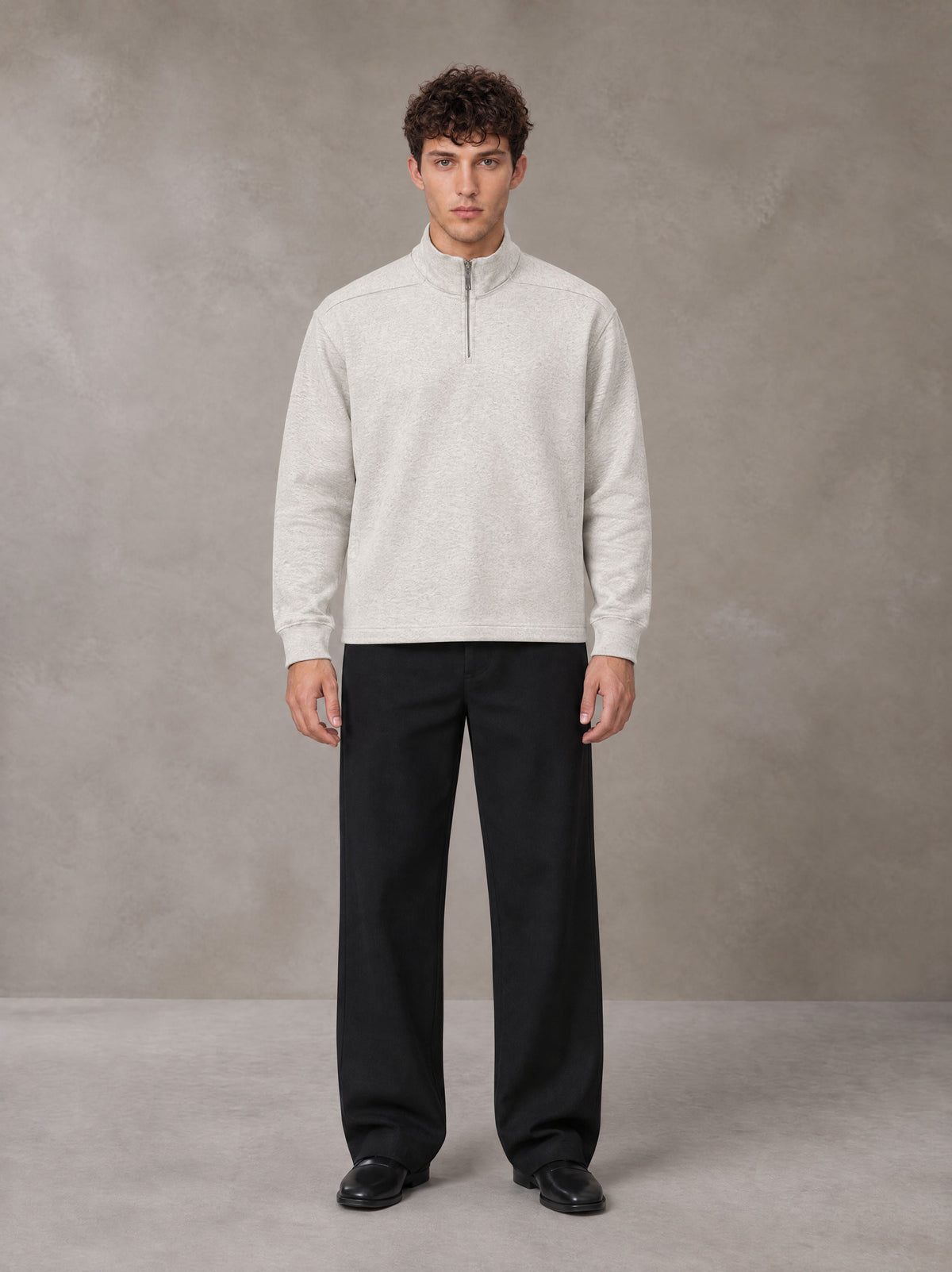 Model wearing SM Sig. Half-Zip Fleece Sweatshirt in Oat Grey, front view.