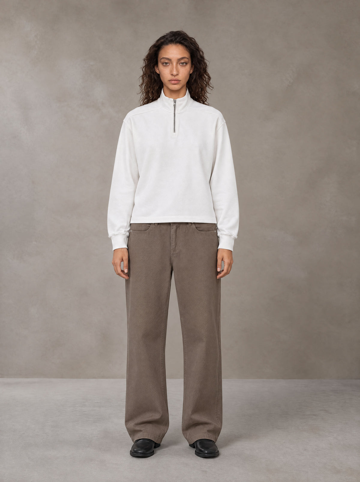 Model wearing SM Sig. Half-Zip Fleece Sweatshirt in Lucent White, front view.