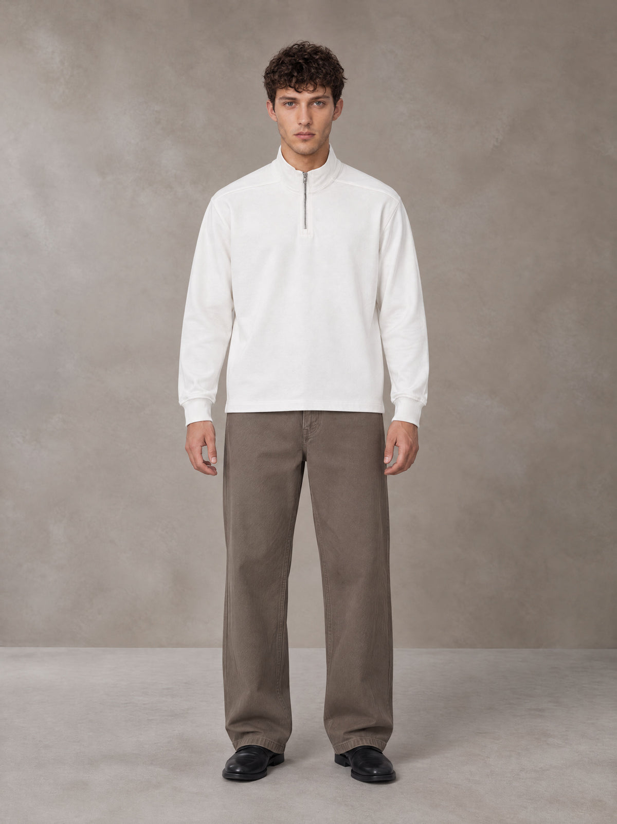 Model wearing SM Sig. Half-Zip Fleece Sweatshirt in Lucent White, front view.