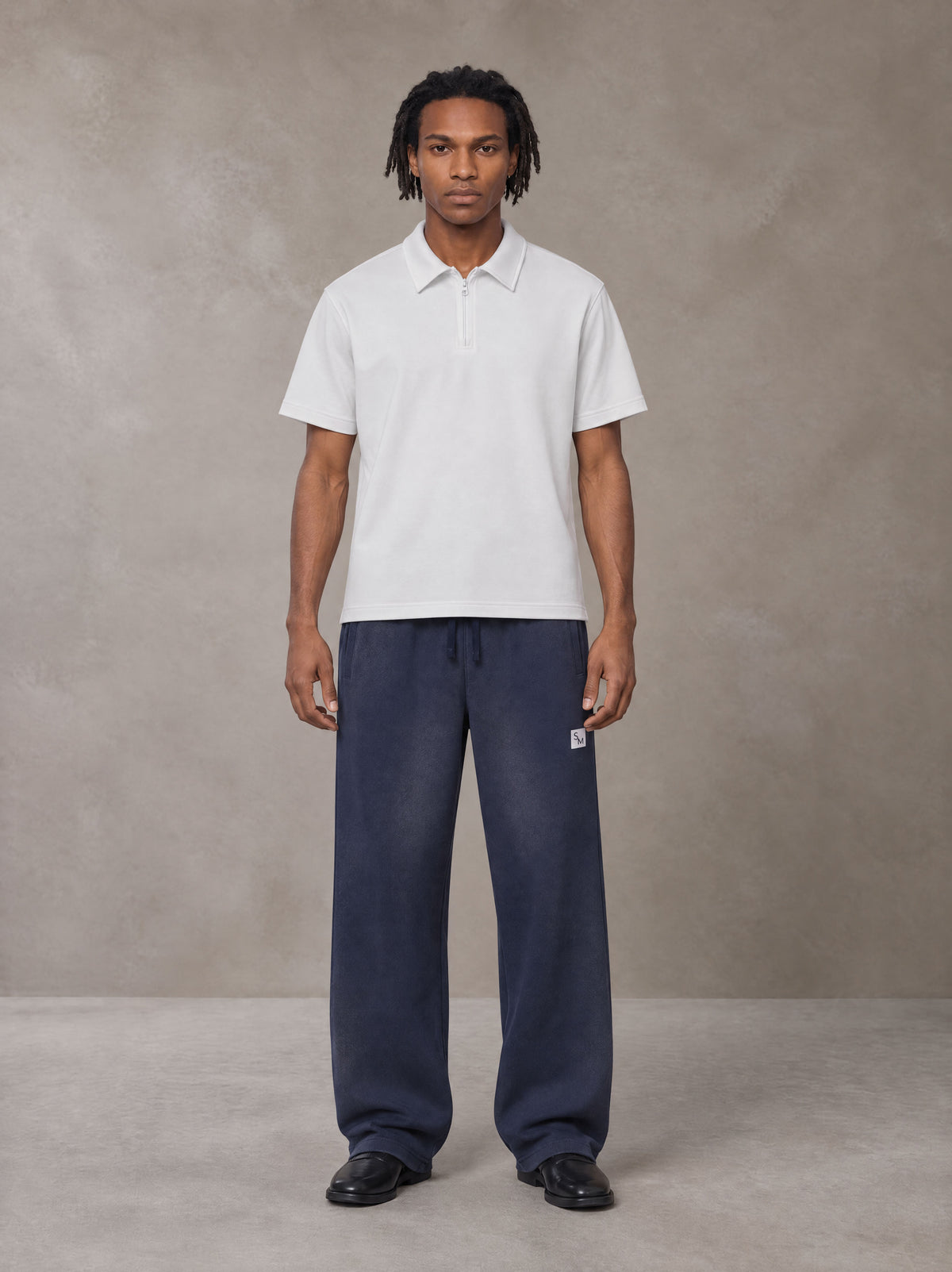 Model wearing SM Sig. Sun Fade Sweatpants in Oxford Navy, front view.