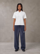 Model wearing SM Sig. Sun Fade Sweatpants in Oxford Navy, front view.