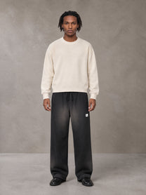 Model wearing SM Sig. Sun Fade Sweatpants in Midnight Black, front view.