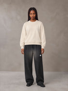 Model wearing SM Sig. Sun Fade Sweatpants in Midnight Black, front view.