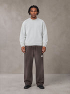 Model wearing SM Sig. Sun Fade Sweatpants in Kabul Brown, front view.