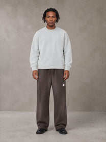 Model wearing SM Sig. Sun Fade Sweatpants in Kabul Brown, front view.