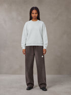 Model wearing SM Sig. Sun Fade Sweatpants in Kabul Brown, front view.