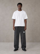 Model wearing SM Snow Fade Sweatpants in Midnight Black, front view.