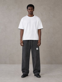 Model wearing SM Snow Fade Sweatpants in Midnight Black, front view.