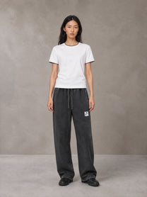 Model wearing SM Snow Fade Sweatpants in Midnight Black, front view.