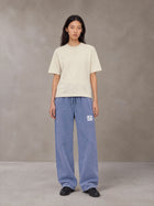 Model wearing SM Snow Fade Sweatpants in Chambray, front view.