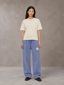 Model wearing SM Snow Fade Sweatpants in Chambray, front view.