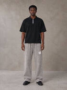 Model wearing SM Snow Fade Sweatpants in Floral Grey, front view.