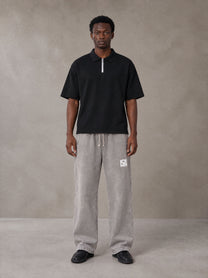 Model wearing SM Snow Fade Sweatpants in Floral Grey, front view.