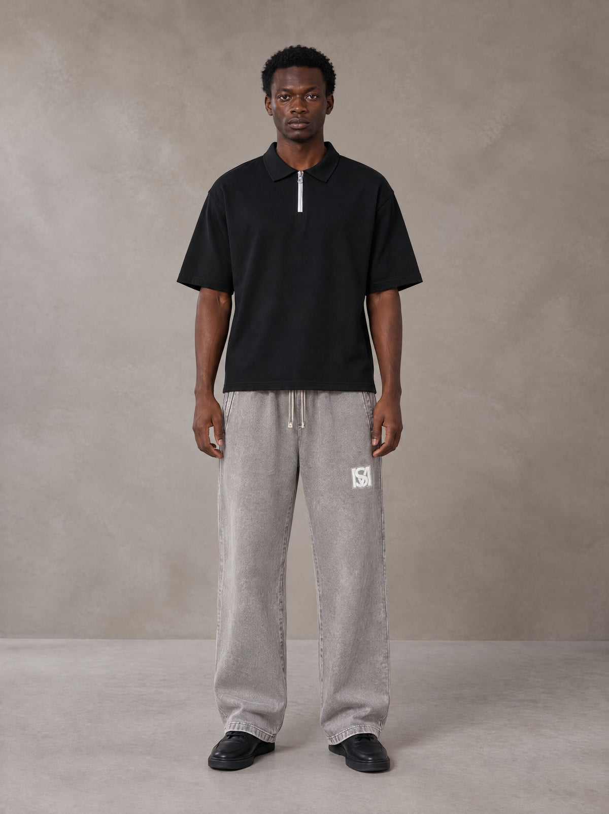 Model wearing SM Snow Fade Sweatpants in Floral Grey, front view.