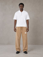 Model wearing SM Snow Fade Sweatpants in Aged Whiskey, front view.
