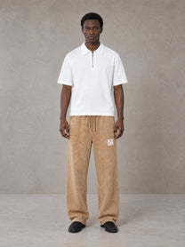 Model wearing SM Snow Fade Sweatpants in Aged Whiskey, front view.
