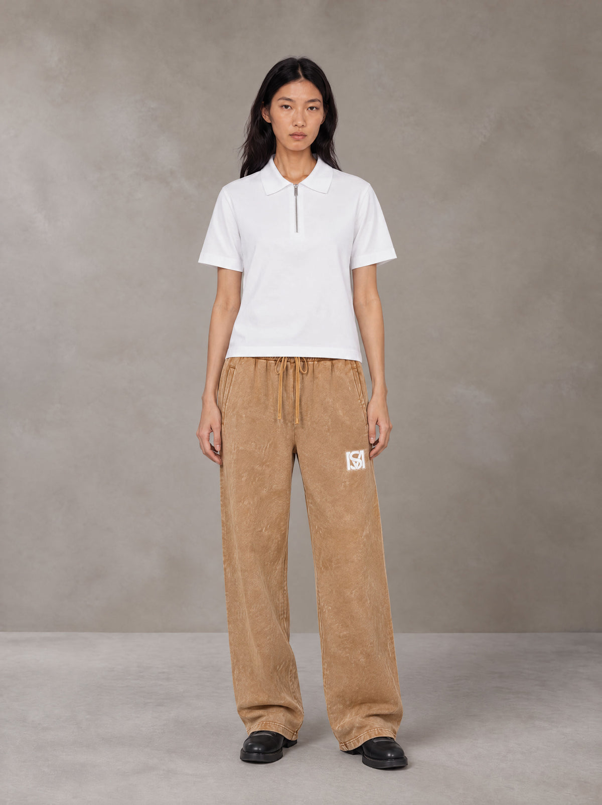 Model wearing SM Snow Fade Sweatpants in Aged Whiskey, front view.