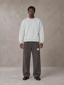 Model wearing SM Snow Fade Sweatpants in Graphite, front view.