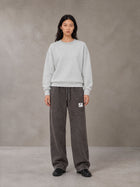 Model wearing SM Snow Fade Sweatpants in Graphite, front view.