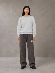 Model wearing SM Snow Fade Sweatpants in Graphite, front view.