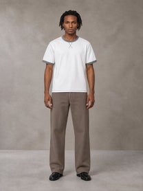 Model wearing SM Sig. Contrast Stitch T-shirt in Lucent White, front view.