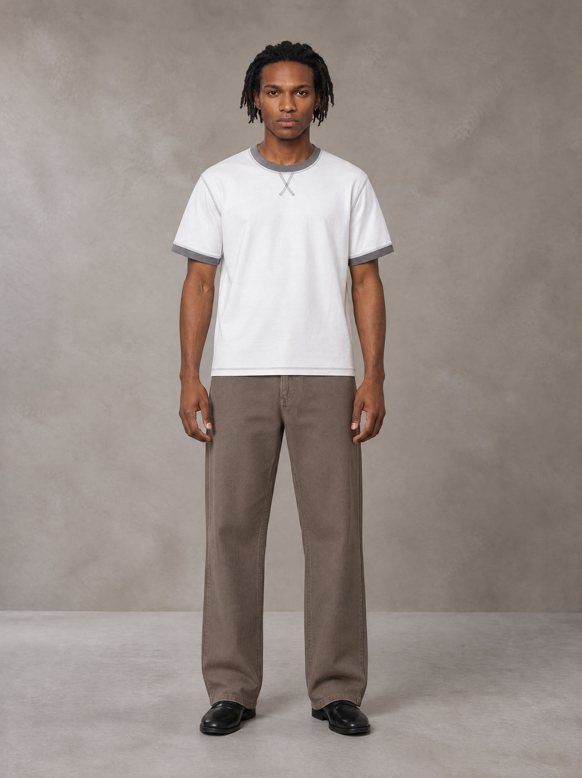 Model wearing SM Sig. Contrast Stitch T-shirt in Lucent White, front view.