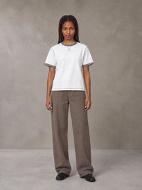 Model wearing SM Sig. Contrast Stitch T-shirt in Lucent White, front view.