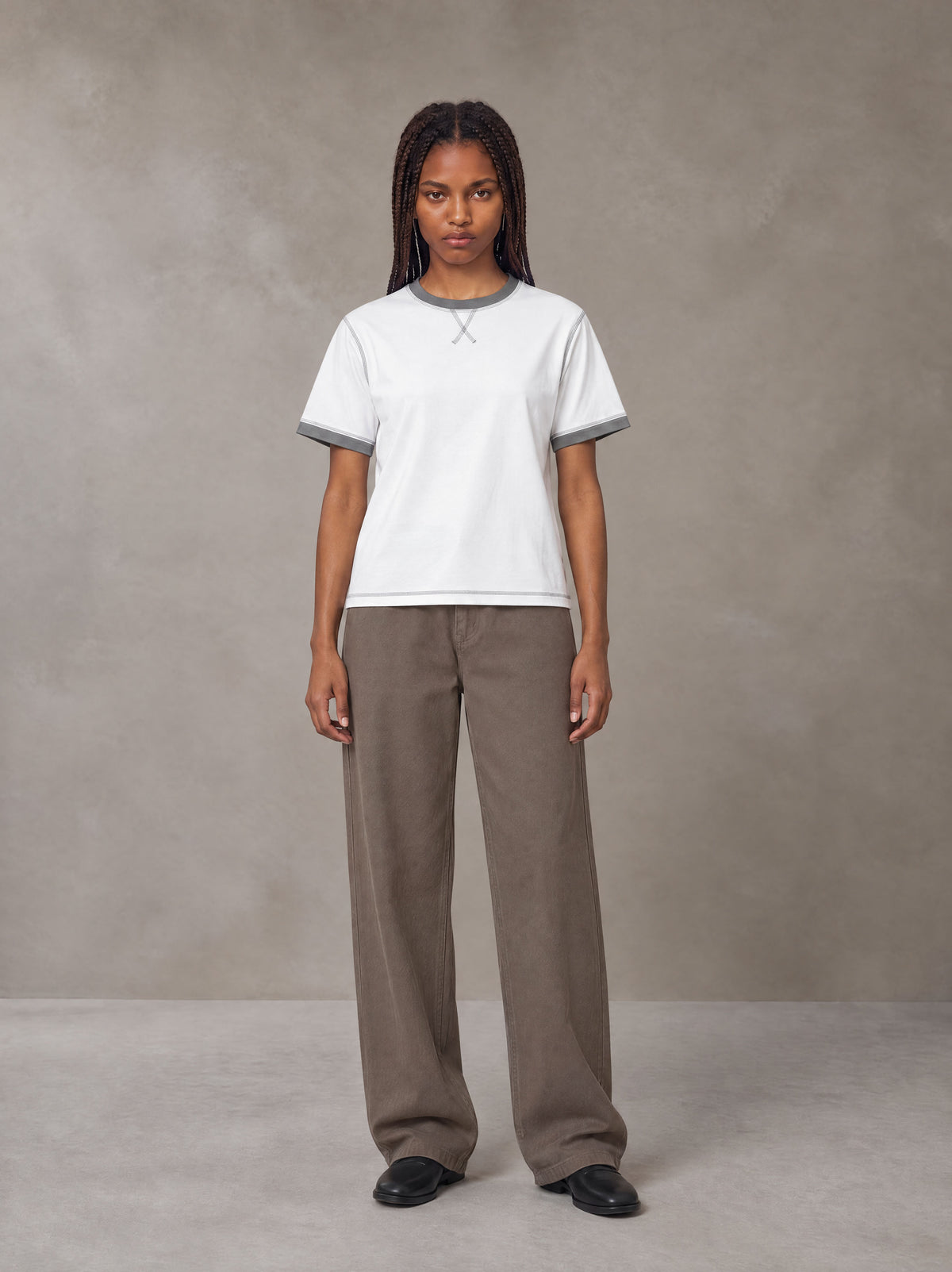 Model wearing SM Sig. Contrast Stitch T-shirt in Lucent White, front view.