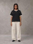 Model wearing SM Sig. Contrast Stitch T-shirt in Midnight Black, front view.
