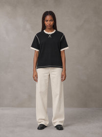 Model wearing SM Sig. Contrast Stitch T-shirt in Midnight Black, front view.