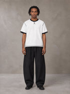 Model wearing SM Sig. Contrast Stitch T-shirt in Lucent White, front view.