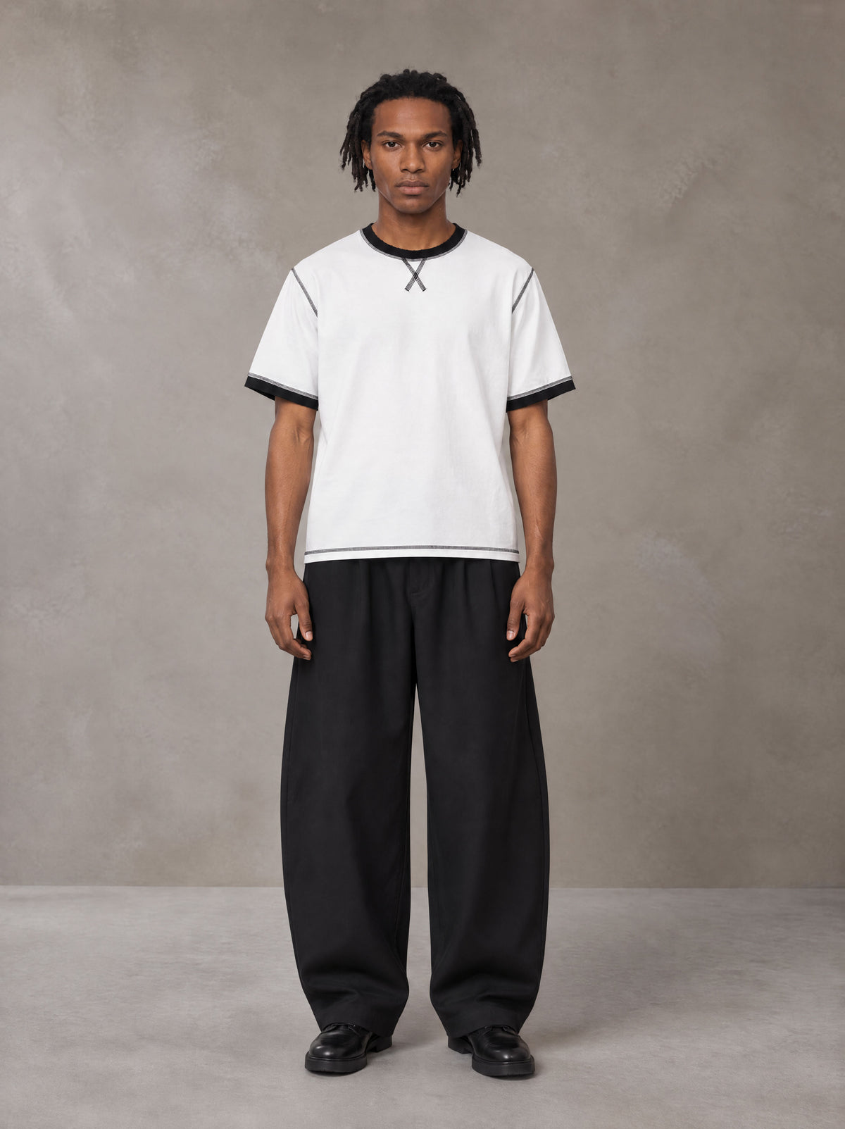 Model wearing SM Sig. Contrast Stitch T-shirt in Lucent White, front view.