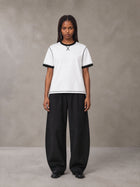 Model wearing SM Sig. Contrast Stitch T-shirt in Lucent White, front view.