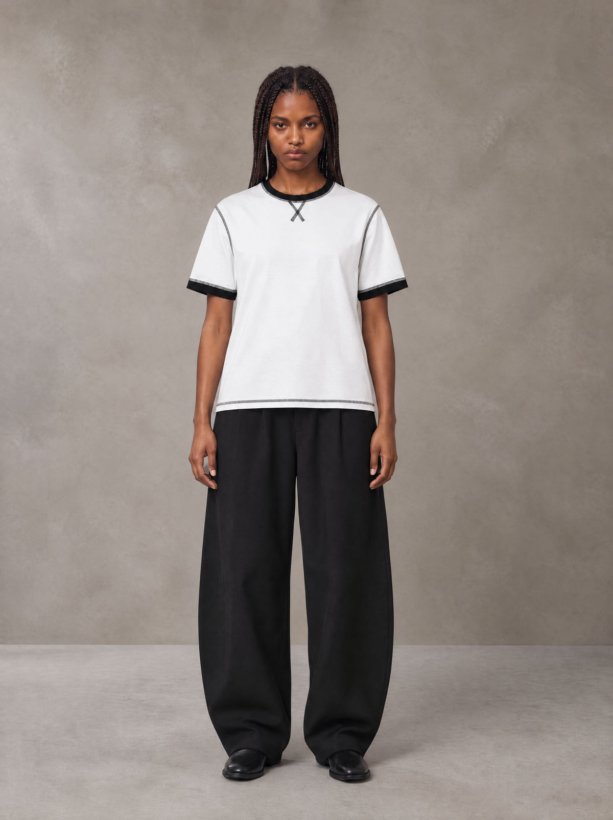 Model wearing SM Sig. Contrast Stitch T-shirt in Lucent White, front view.
