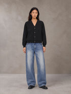 Model wearing SM Sig. Cardigan in Midnight Black, front view.