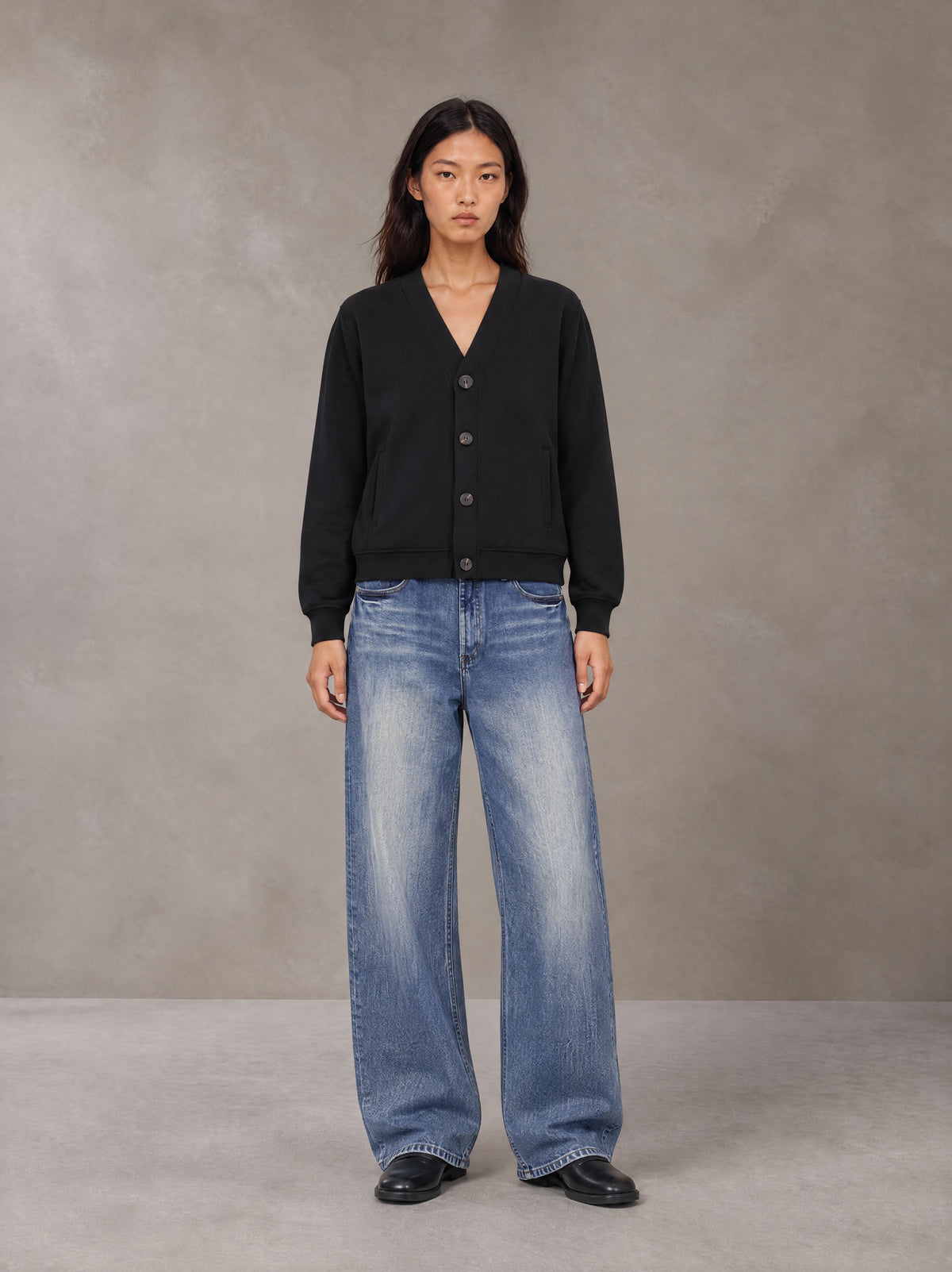 Model wearing SM Sig. Cardigan in Midnight Black, front view.