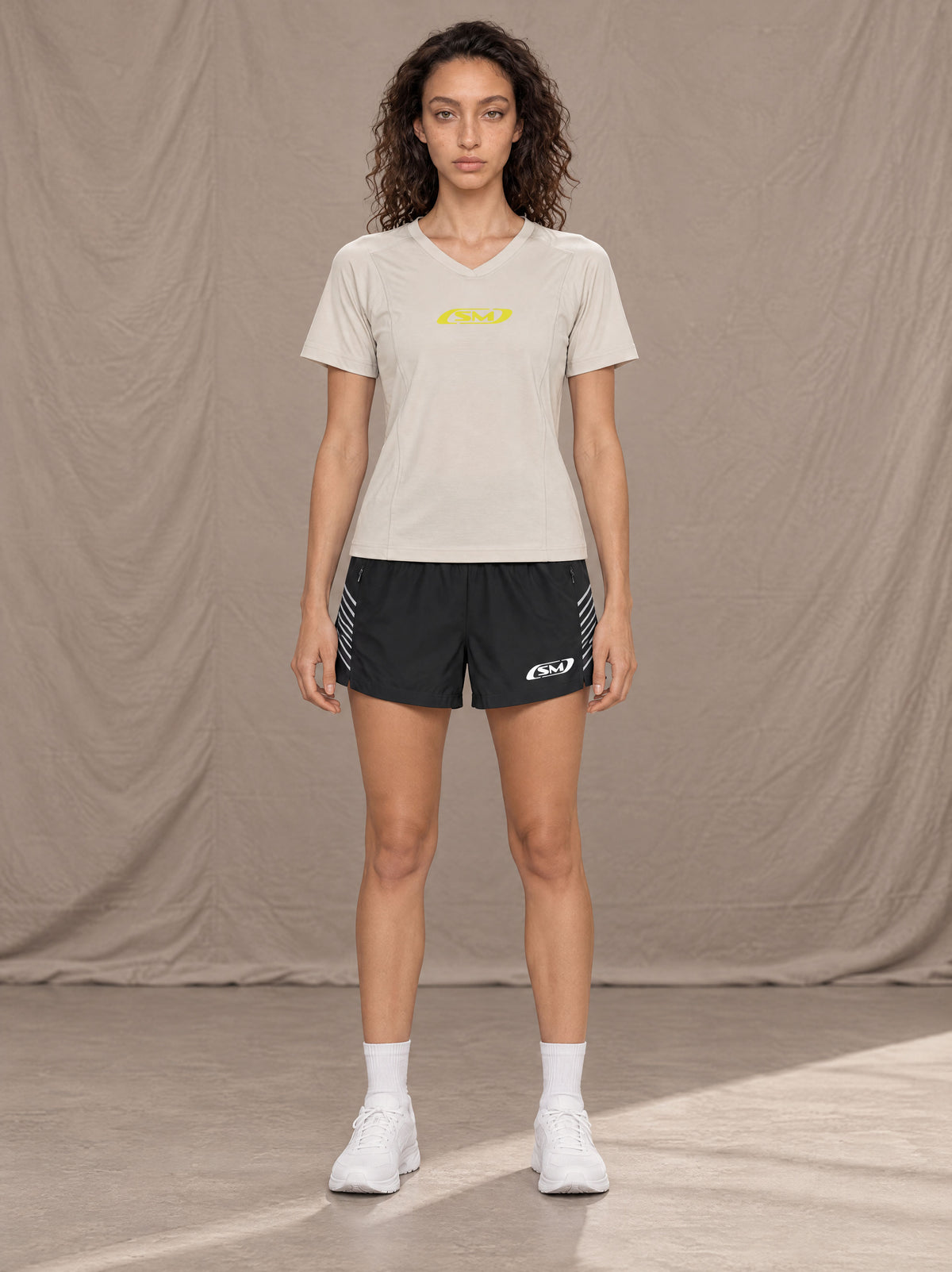 Model wearing SM Motion Stride Shorts in Midnight Black, front view.