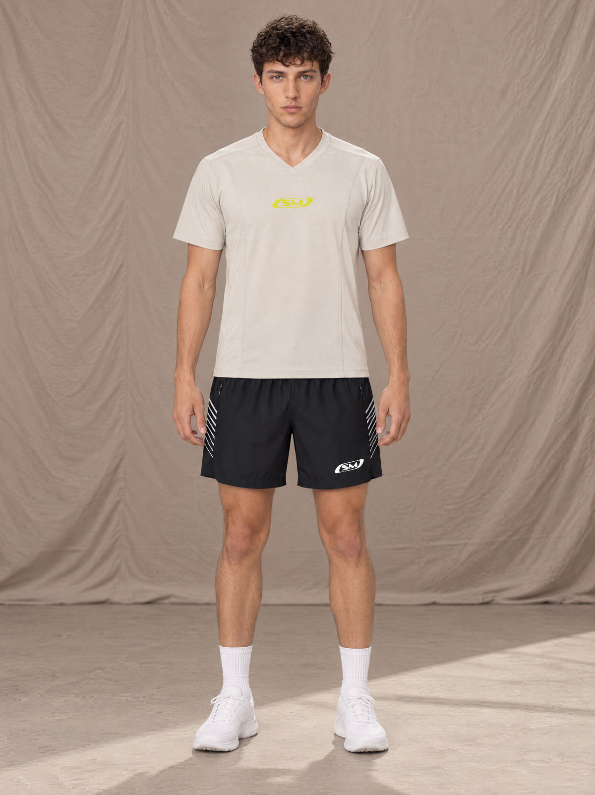 Model wearing SM Motion Stride Shorts in Midnight Black, front view.