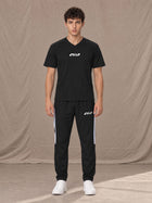 Model wearing SM Motion Stripe Track Trousers in Midnight Black, front view.