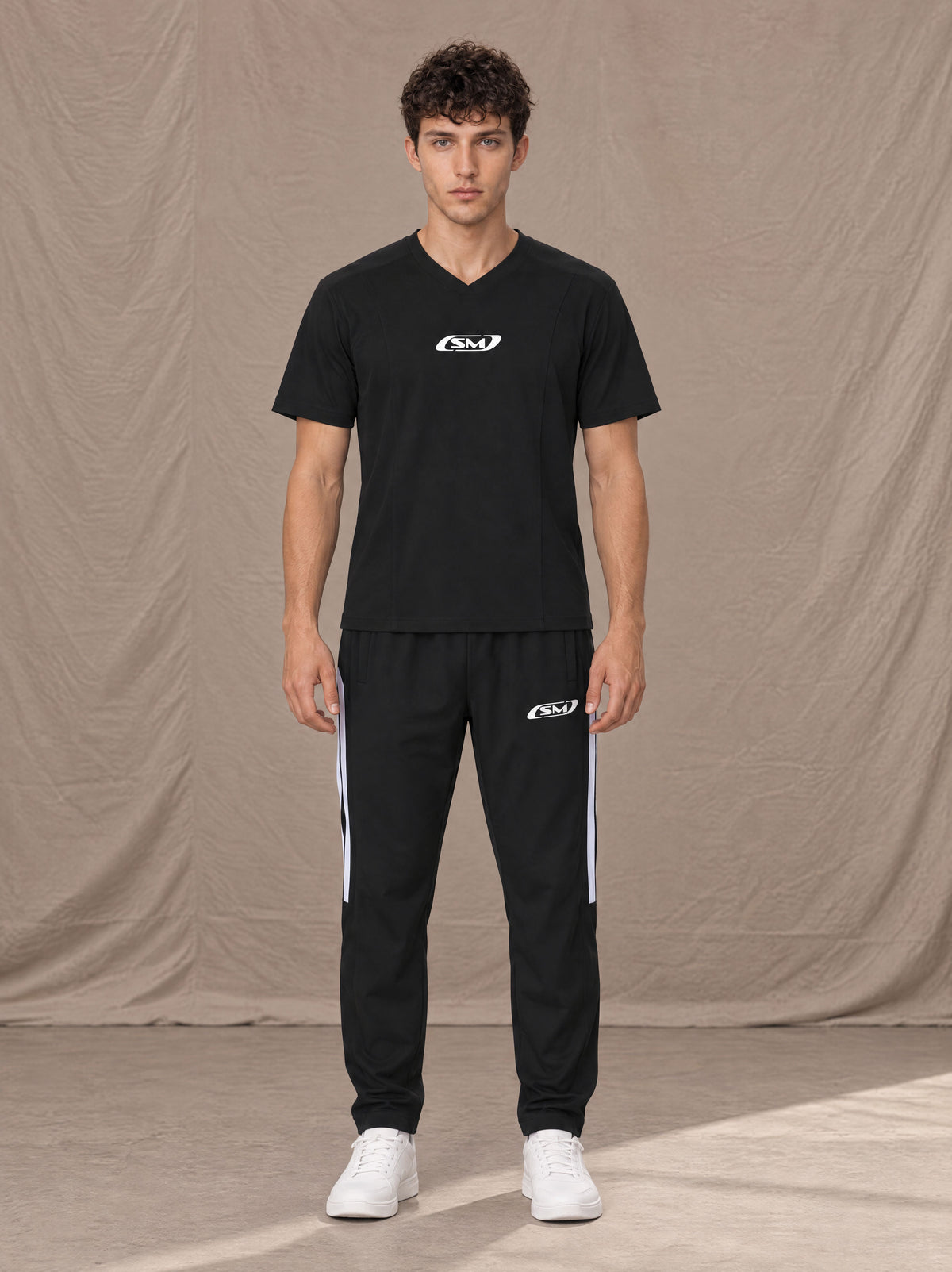 Model wearing SM Motion Stripe Track Trousers in Midnight Black, front view.