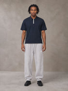 Model wearing SM Sig. Jogger Sweatpants in Floral Grey, front view.