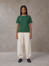 Model wearing SM Sig. Jogger Sweatpants in Oat Grey, front view.