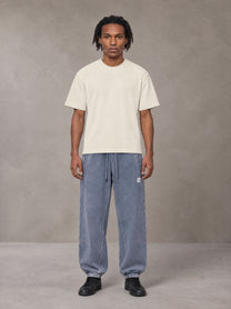 Model wearing SM Sig. Jogger Sweatpants in Washed Blue Jean, front view.