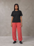 Model wearing SM Sig. Jogger Sweatpants in Watermelon Tint, front view.
